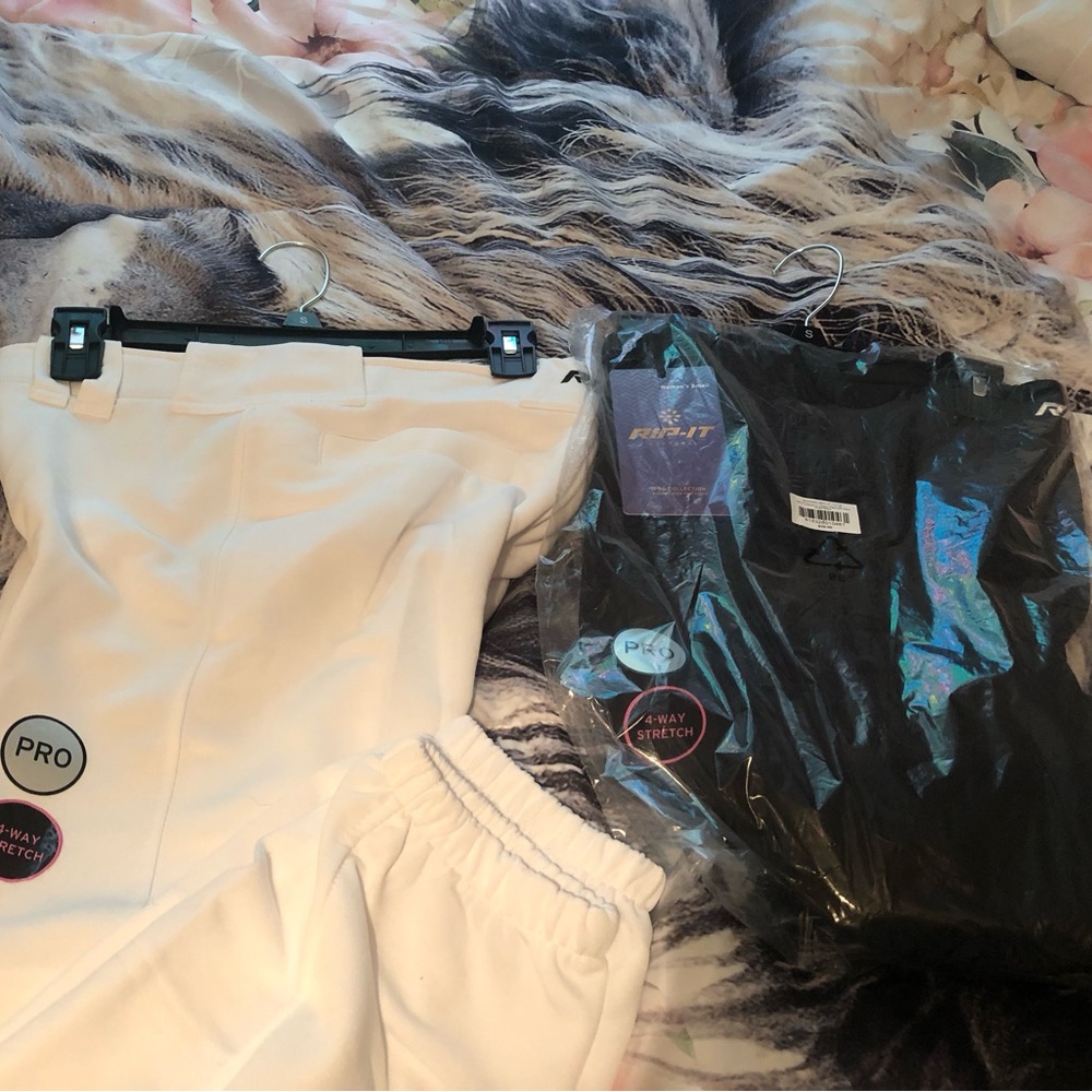 2 pairs of Women’s Small Rip It softball pants. 1 full black. 1 full white.